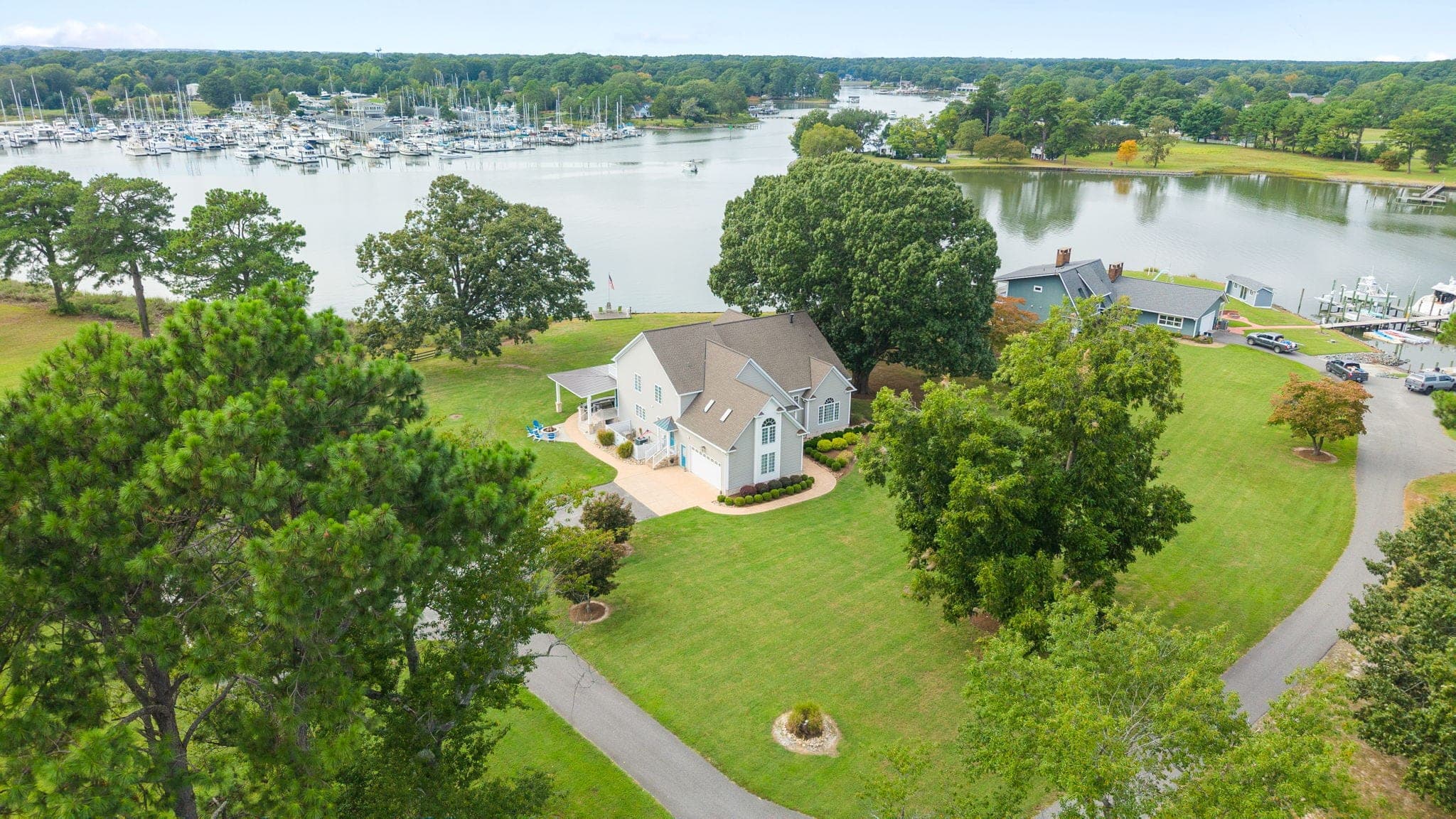 From above: the house on its point, Sarah's Creek wrapping the lawn, and the marina a few hundred yards across the water.