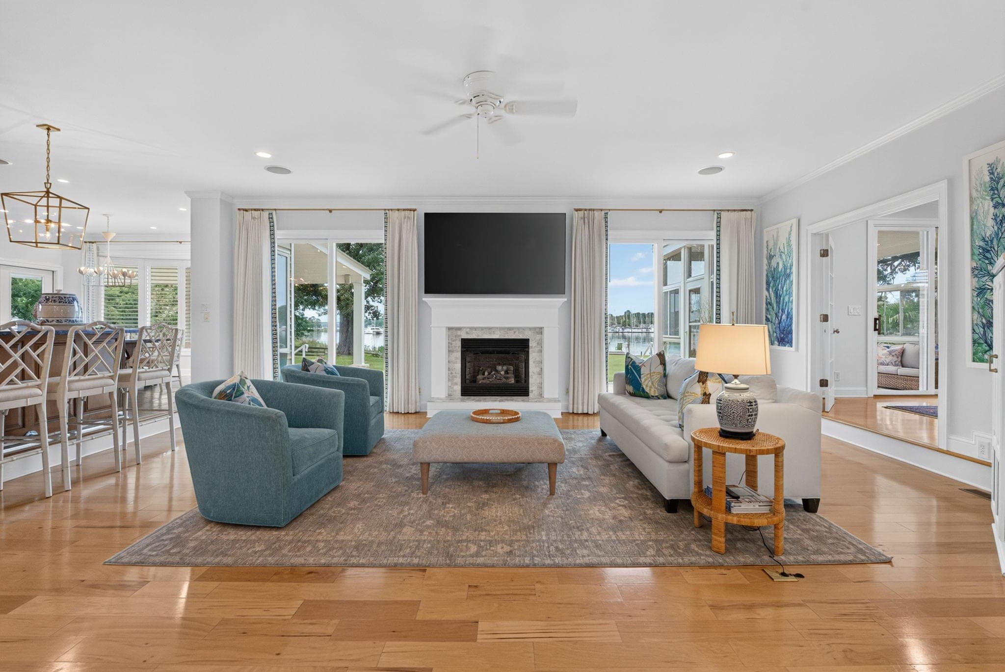 The living room: a gas fireplace under the television, walls of glass to the creek on two sides.