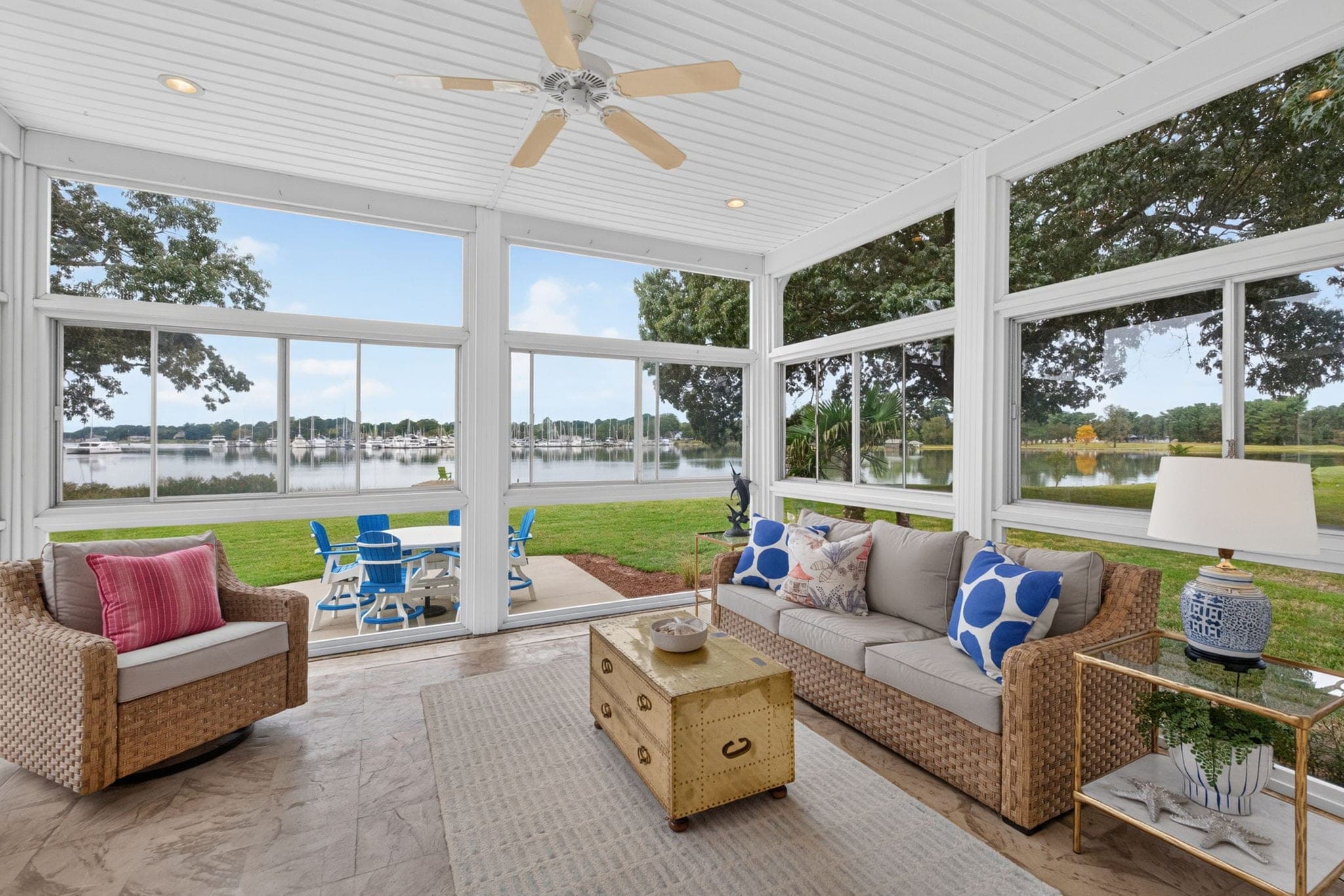 The all-weather EZ-Breeze porch: the creek on three sides, the marina on the horizon.